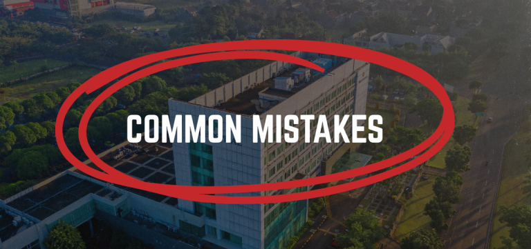 Aerial view of a building with COMMON MISTAKES in bold white text and a large red oval circling the text, overlayed on the image. - Anderson Smith Group